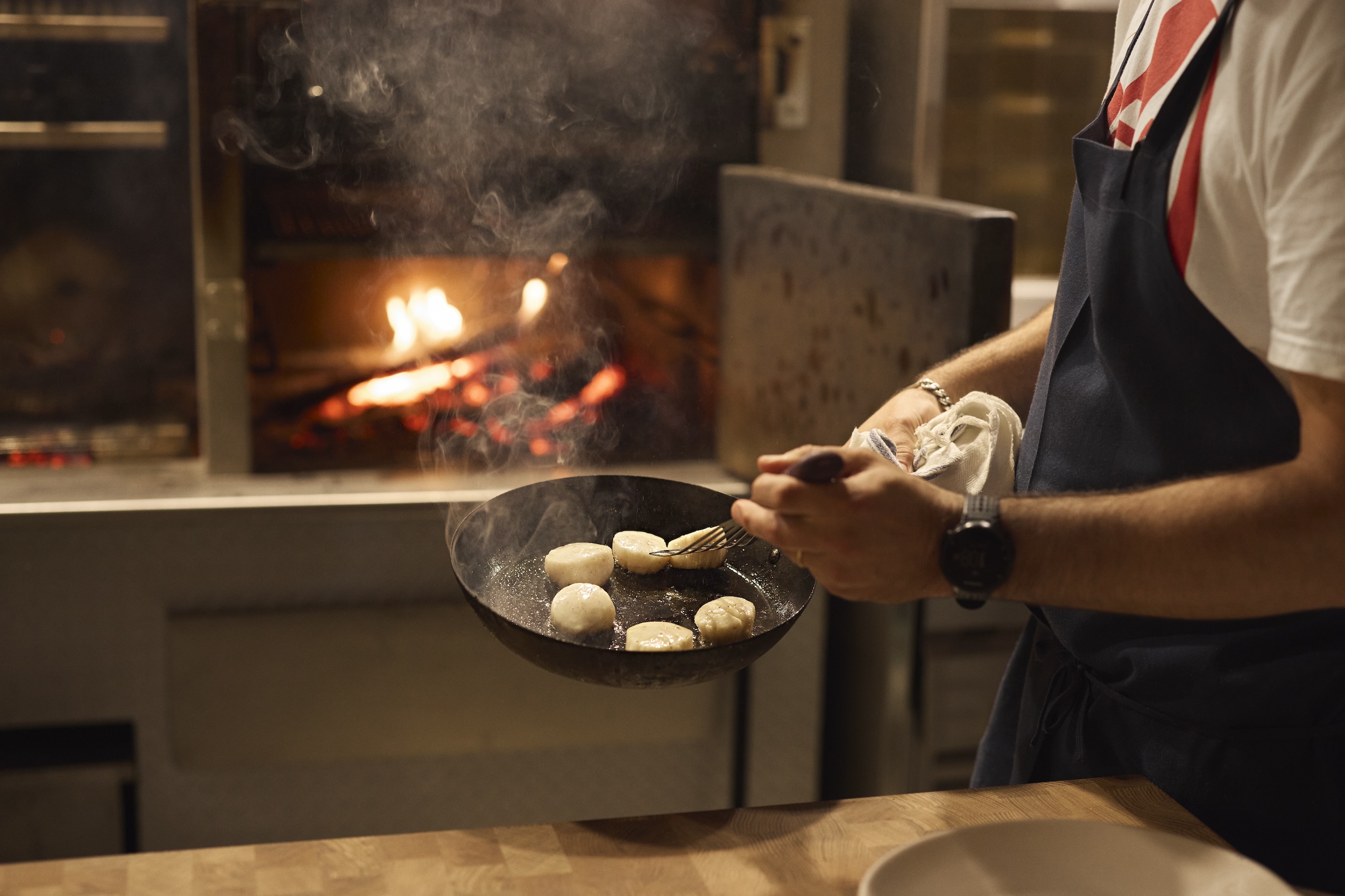 Chef cooking over flames