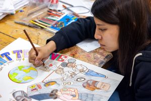 Allison Katz Poster Project – a colourful poster being illustrated by a student