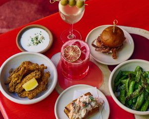 Selection of food and cocktails on a red table