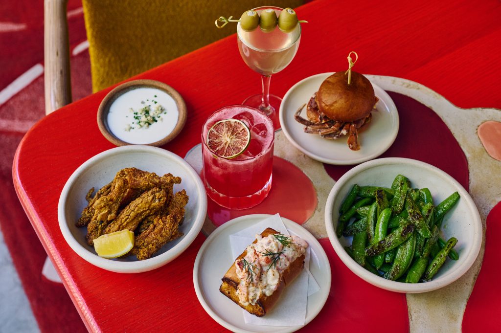 Selection of food and cocktails on a red table