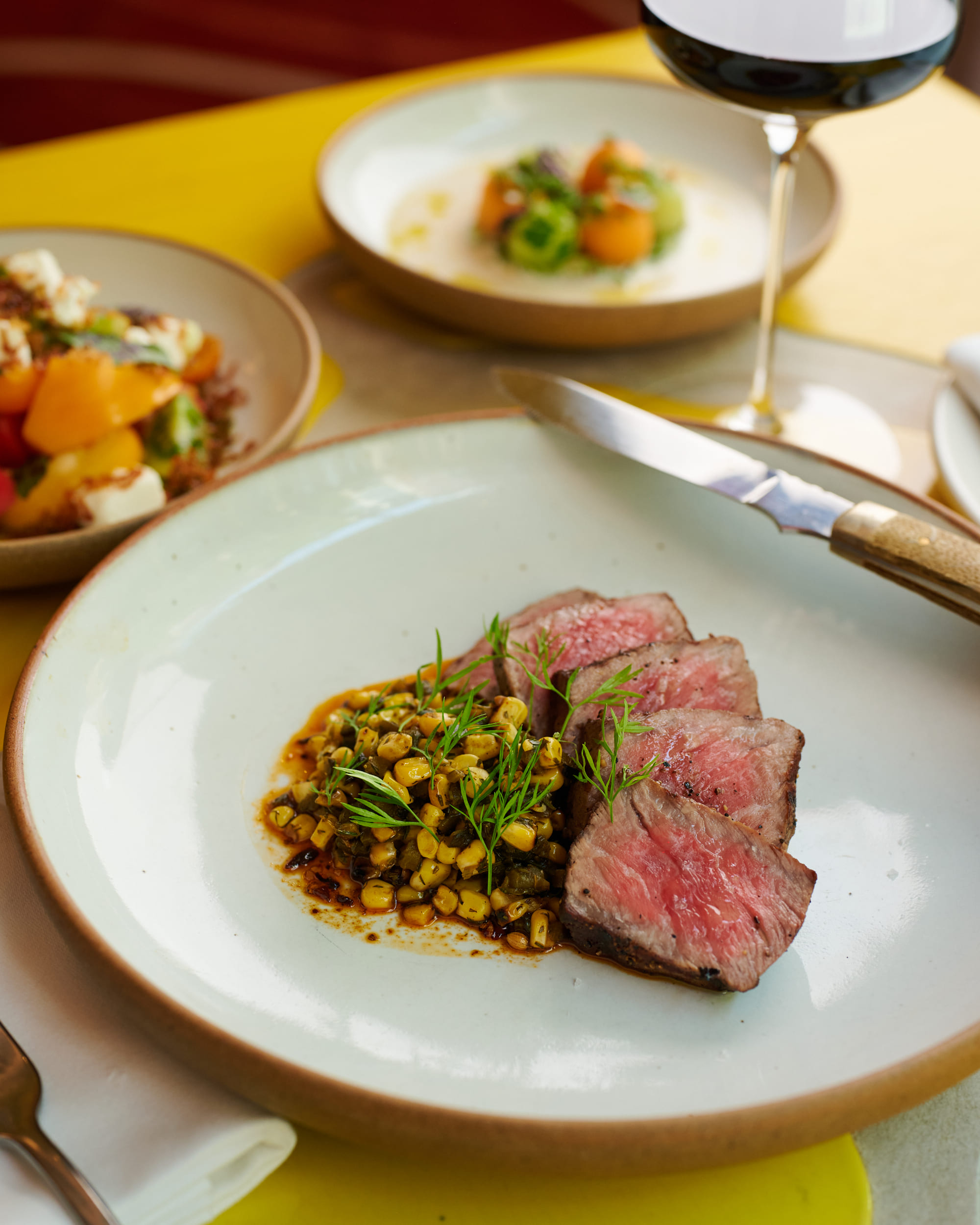 Restaurant Week tables cape including strip loin with corn poblano in the focus
